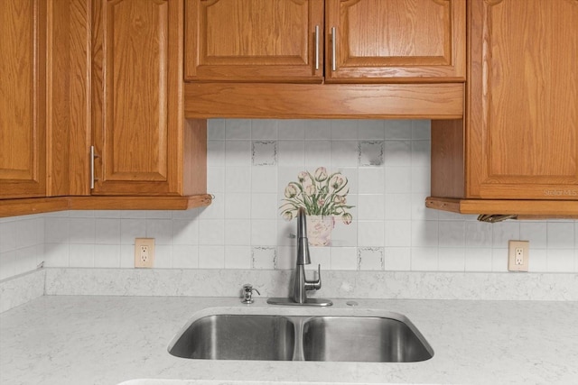 841 N Palm Springs Ter, Crystal River, FL 34429 - kitchen with brown cabinetry, tasteful backsplash, and a sink
