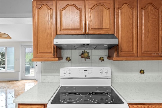 841 N Palm Springs Ter, Crystal River, FL 34429 - kitchen featuring backsplash, light countertops, electric stove, and under cabinet range hood