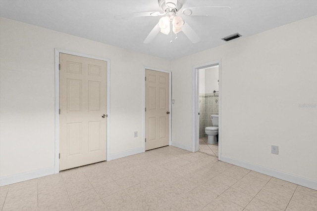 841 N Palm Springs Ter, Crystal River, FL 34429 - unfurnished bedroom featuring baseboards, visible vents, and ensuite bath