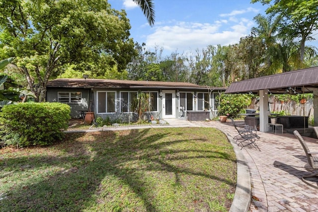 841 N Palm Springs Ter, Crystal River, FL 34429 - back of house featuring a patio, stucco siding, a sunroom, and a lawn