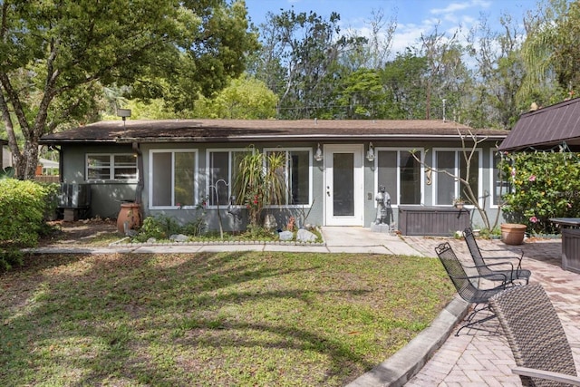 841 N Palm Springs Ter, Crystal River, FL 34429 - ranch-style house featuring a patio, stucco siding, and a front lawn