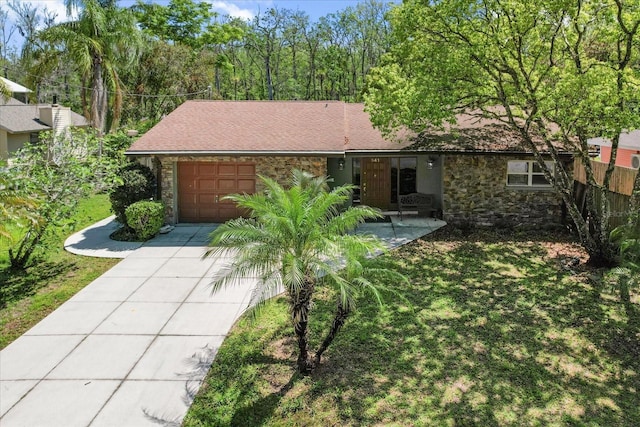 841 N Palm Springs Ter, Crystal River, FL 34429 - view of front of property with a front yard, driveway, stone siding, and an attached garage