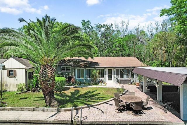 841 N Palm Springs Ter, Crystal River, FL 34429 - rear view of house featuring a sunroom, a patio, and a lawn