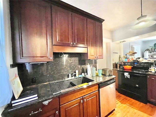 1035 NE 3rd Ave, Gainesville, FL 32601 - kitchen featuring dishwasher, a sink, decorative backsplash, light wood-style floors, and hanging light fixtures