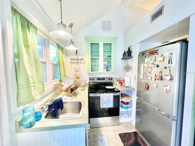 1035 NE 3rd Ave, Gainesville, FL 32601 - kitchen with appliances with stainless steel finishes, vaulted ceiling, light tile patterned flooring, light countertops, and glass insert cabinets