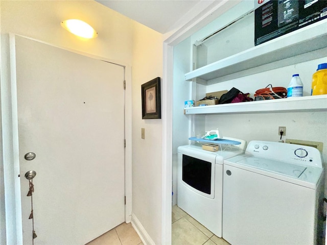 1035 NE 3rd Ave, Gainesville, FL 32601 - washroom with light tile patterned floors and washing machine and dryer