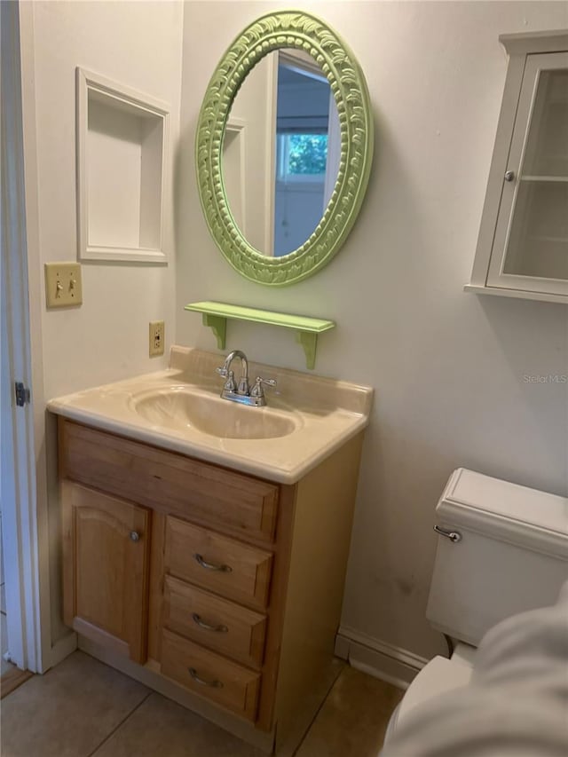 1035 NE 3rd Ave, Gainesville, FL 32601 - bathroom with vanity, tile patterned flooring, toilet, and baseboards