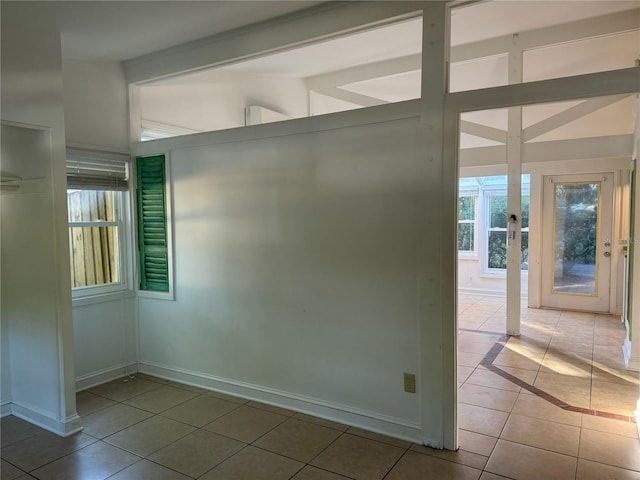 1035 NE 3rd Ave, Gainesville, FL 32601 - spare room featuring tile patterned floors and baseboards