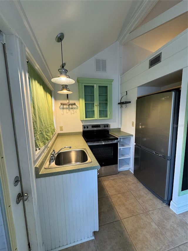 1035 NE 3rd Ave, Gainesville, FL 32601 - kitchen featuring freestanding refrigerator, stainless steel electric stove, lofted ceiling, a sink, and light tile patterned floors