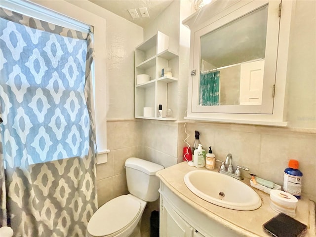 1035 NE 3rd Ave, Gainesville, FL 32601 - full bath with vanity, tile walls, toilet, a shower with shower curtain, and decorative backsplash