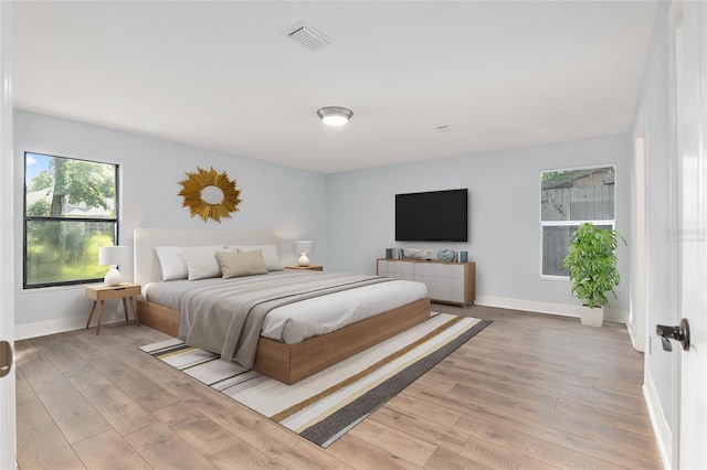 6840 NW 111th Ln, Alachua, FL 32615 - bedroom featuring visible vents, baseboards, and light wood-style floors