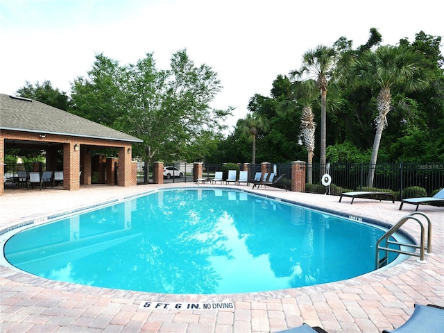 8941 SW 73rd Ln, Gainesville, FL 32608 - community pool featuring a patio area