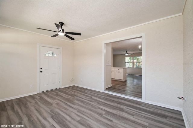 interior space with a textured ceiling, wood finished floors, and ceiling fan