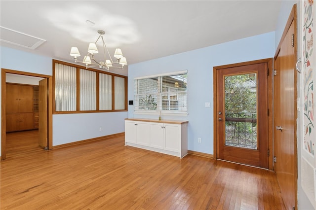 2210 NW 6th Pl, Gainesville, FL 32603 - foyer with light wood-style floors, baseboards, and a chandelier