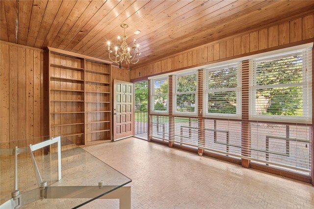 2210 NW 6th Pl, Gainesville, FL 32603 - unfurnished sunroom featuring a chandelier