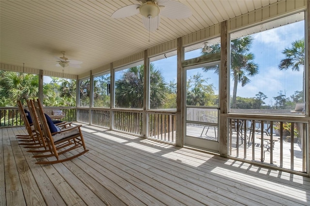 unfurnished sunroom featuring a ceiling fan