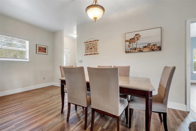 dining room with wood finished floors and baseboards