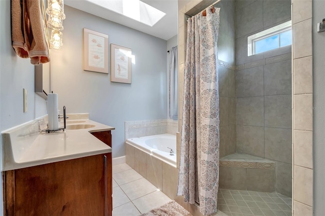 bathroom featuring a tile shower, a skylight, tile patterned flooring, and a garden tub