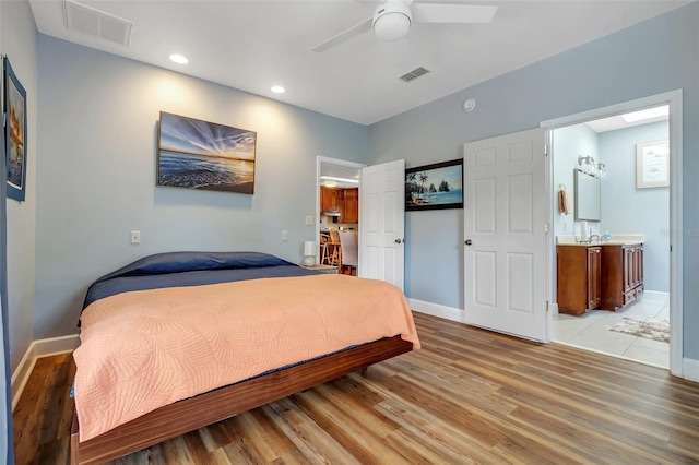 bedroom with light wood-style floors, recessed lighting, visible vents, and baseboards