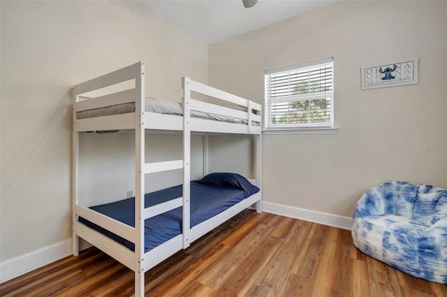 bedroom featuring wood finished floors and baseboards
