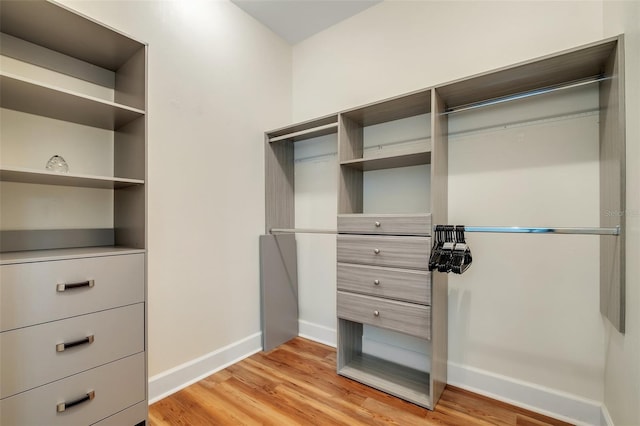 walk in closet featuring light wood-style flooring