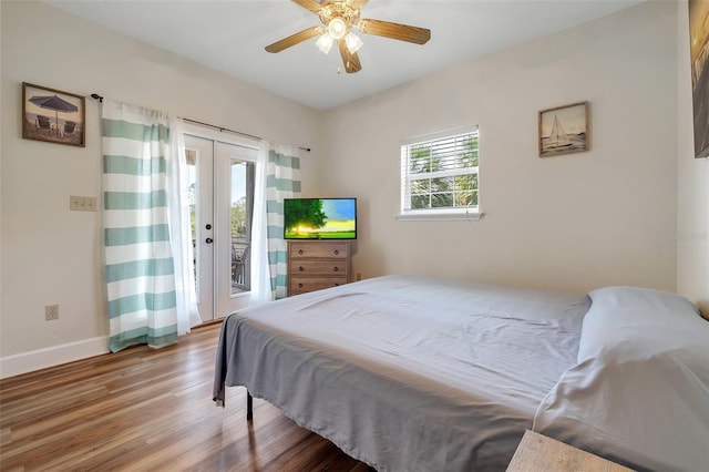 bedroom featuring baseboards, access to outside, ceiling fan, and wood finished floors