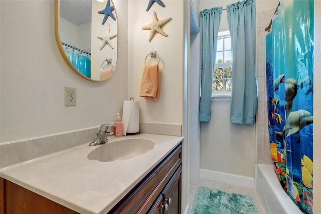 full bath with tile patterned flooring, vanity, and baseboards