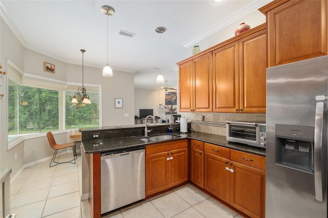 3802 SW 93rd Ter, Gainesville, FL 32608 - kitchen with appliances with stainless steel finishes, a sink, brown cabinetry, a peninsula, and light tile patterned floors