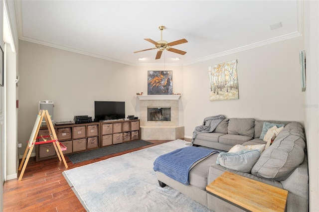 3802 SW 93rd Ter, Gainesville, FL 32608 - living area featuring a ceiling fan, ornamental molding, wood finished floors, a fireplace, and baseboards