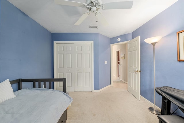 3802 SW 93rd Ter, Gainesville, FL 32608 - bedroom featuring light carpet, a closet, a ceiling fan, and baseboards