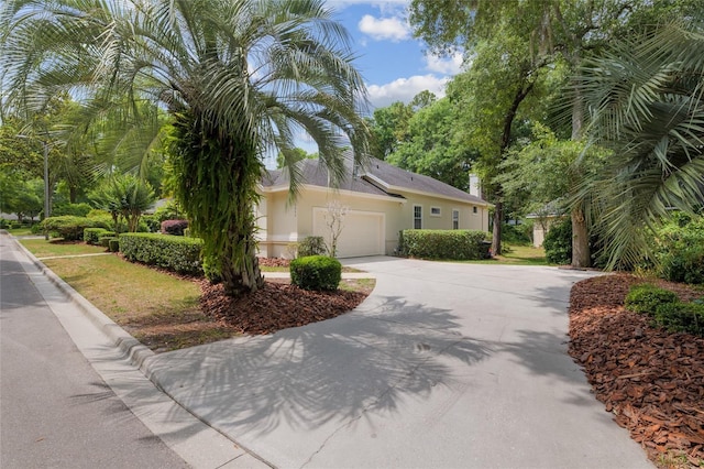 3802 SW 93rd Ter, Gainesville, FL 32608 - view of front of property with driveway, stucco siding, and an attached garage