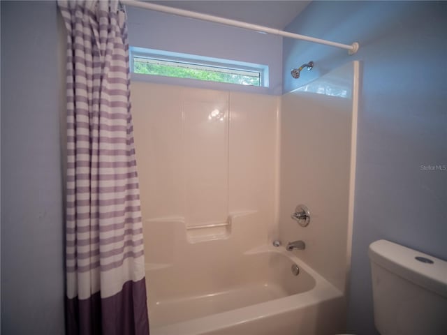 bathroom with toilet and shower / bath combo