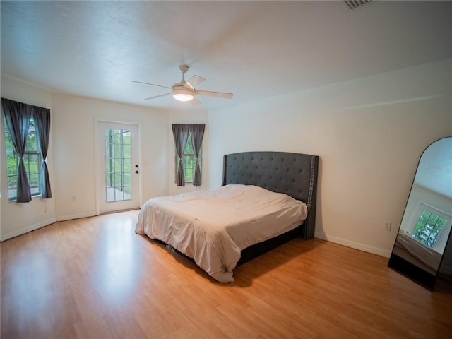 bedroom featuring light wood-style floors, access to outside, baseboards, and ceiling fan
