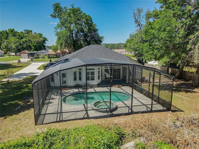 view of swimming pool featuring a fenced in pool, a patio, a lawn, and a lanai