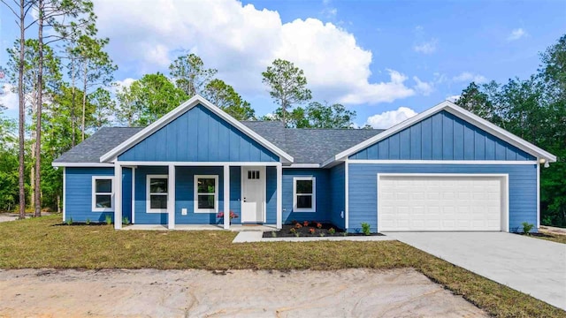 10055 Fox Hollow Dr, Hampton, FL 32044 - view of front of house featuring board and batten siding, a porch, a front lawn, an attached garage, and concrete driveway