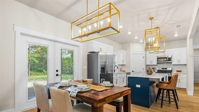 10055 Fox Hollow Dr, Hampton, FL 32044 - dining space with light wood-style flooring, an inviting chandelier, visible vents, and recessed lighting