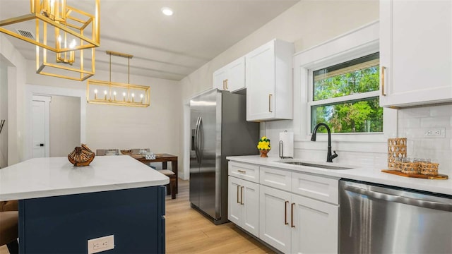 10055 Fox Hollow Dr, Hampton, FL 32044 - kitchen featuring an inviting chandelier, light countertops, decorative backsplash, stainless steel appliances, and a sink