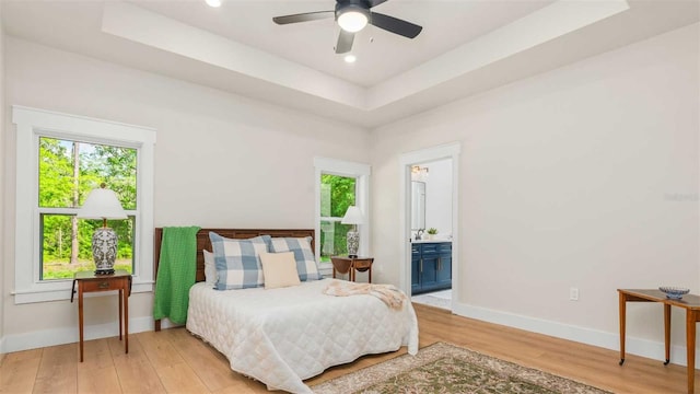 10055 Fox Hollow Dr, Hampton, FL 32044 - bedroom with baseboards, recessed lighting, ensuite bathroom, a raised ceiling, and light wood finished floors