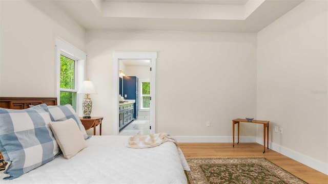 10055 Fox Hollow Dr, Hampton, FL 32044 - bedroom with ensuite bathroom, baseboards, and wood finished floors