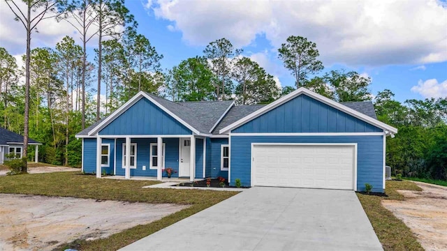 10055 Fox Hollow Dr, Hampton, FL 32044 - view of front of house with board and batten siding, driveway, a garage, and a porch
