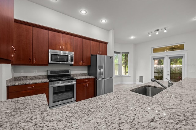 6382 SW 48th Dr, Gainesville, FL 32608 - kitchen with appliances with stainless steel finishes, french doors, light stone countertops, and recessed lighting