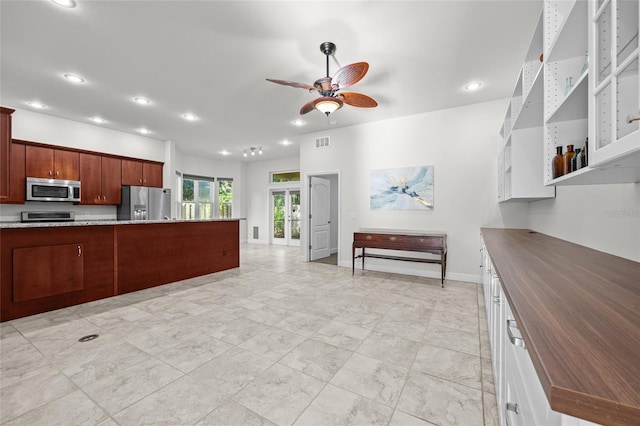 6382 SW 48th Dr, Gainesville, FL 32608 - kitchen featuring appliances with stainless steel finishes, ceiling fan, recessed lighting, light marble finish flooring, and wooden counters