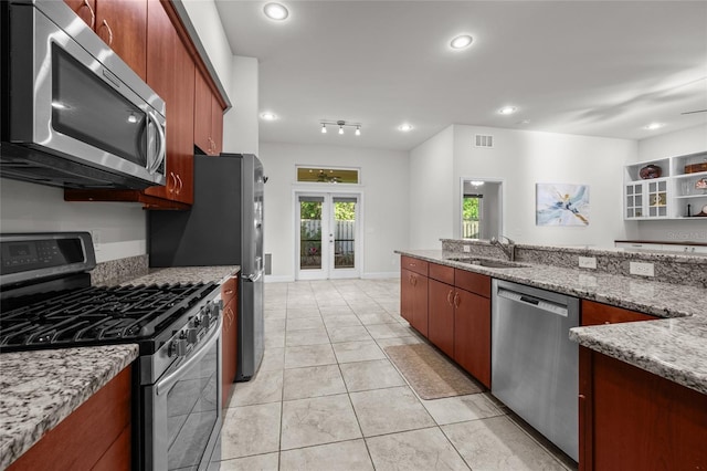 6382 SW 48th Dr, Gainesville, FL 32608 - kitchen featuring appliances with stainless steel finishes, french doors, light stone counters, light tile patterned floors, and recessed lighting