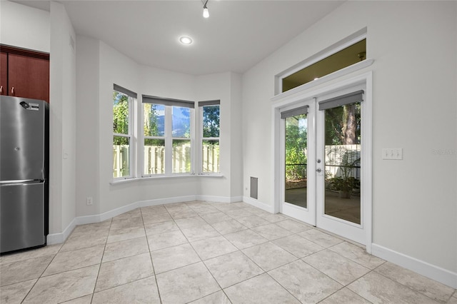 6382 SW 48th Dr, Gainesville, FL 32608 - unfurnished dining area with plenty of natural light, light tile patterned flooring, and french doors