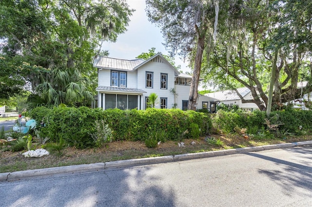 562 NE 2nd Ave, Gainesville, FL 32601 - view of front of home with a sunroom and a metal roof