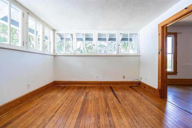 562 NE 2nd Ave, Gainesville, FL 32601 - unfurnished room with hardwood / wood-style floors and a textured ceiling