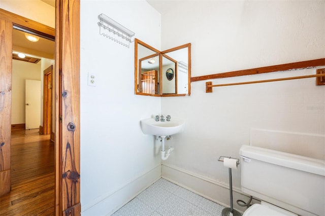562 NE 2nd Ave, Gainesville, FL 32601 - bathroom featuring toilet and baseboards