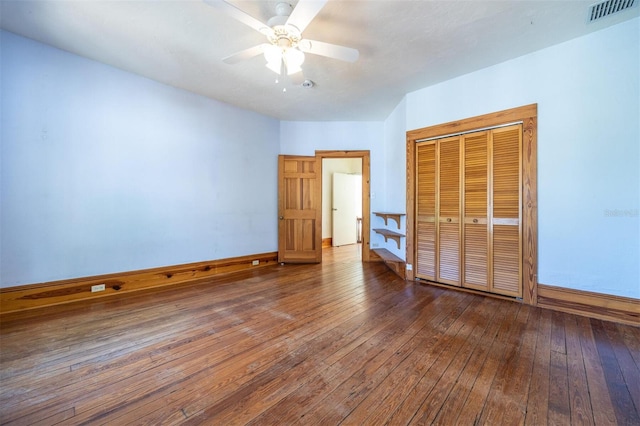 562 NE 2nd Ave, Gainesville, FL 32601 - unfurnished bedroom with wood-type flooring, a closet, and a ceiling fan