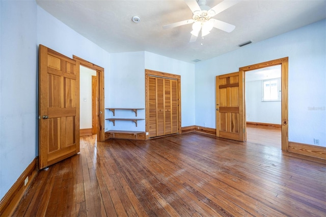 562 NE 2nd Ave, Gainesville, FL 32601 - unfurnished bedroom featuring hardwood / wood-style floors, a closet, and a ceiling fan