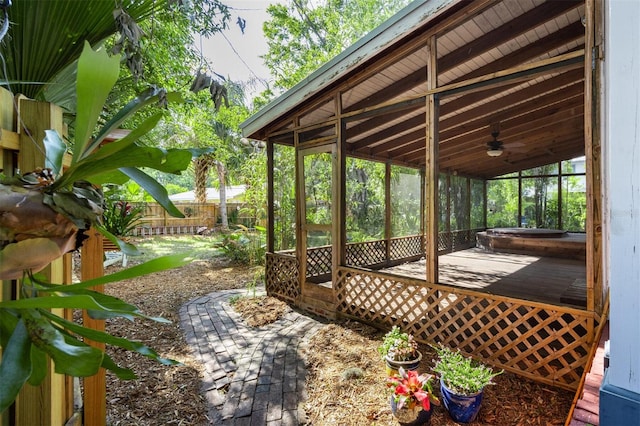 562 NE 2nd Ave, Gainesville, FL 32601 - fenced backyard featuring a ceiling fan, a deck, and a sunroom